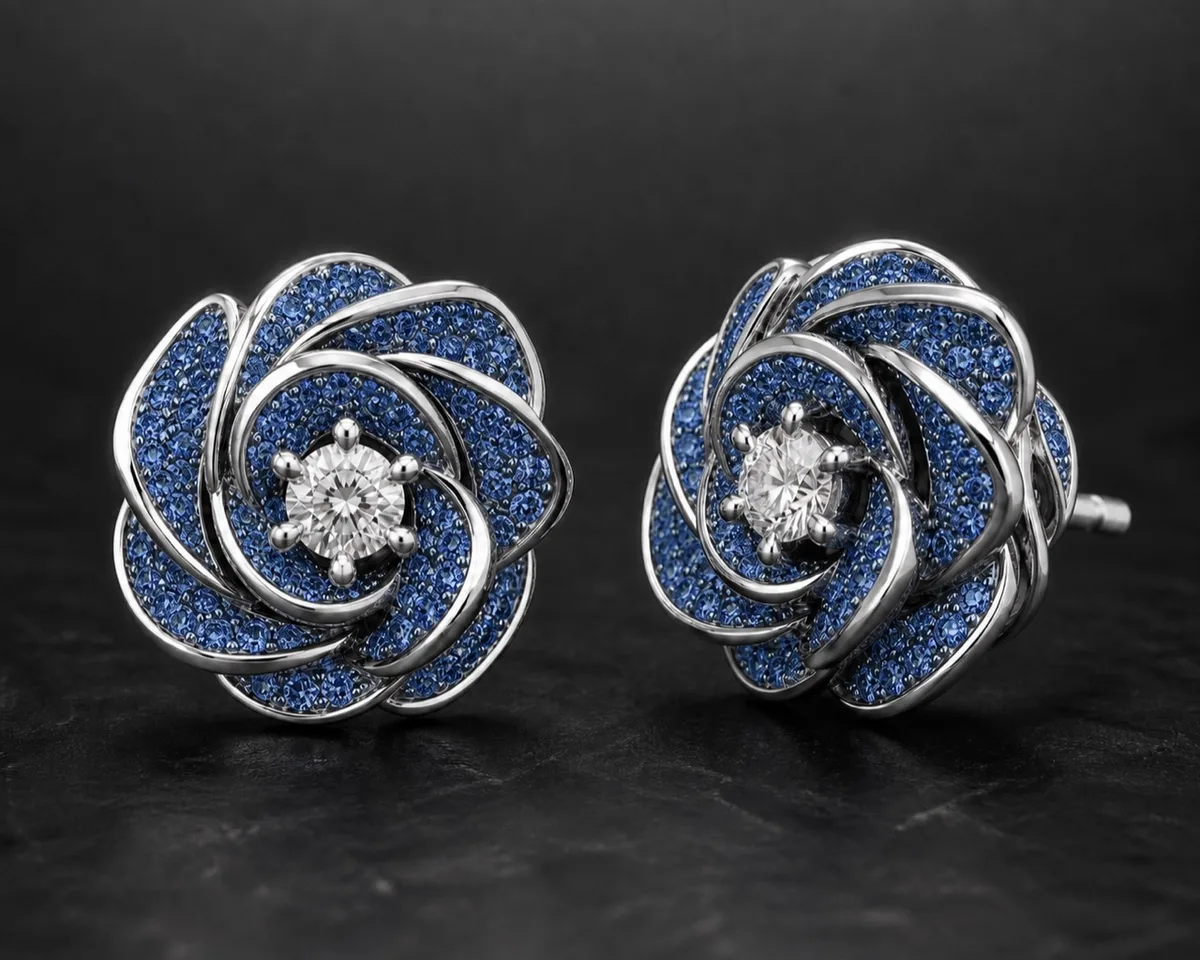 Matching Donya Midnight Bloom white-gold earrings with blue-diamond pavé petals and white center diamonds